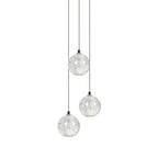 Three clear spheres of this Clérachic pendant light hang at different heights on thin cords against white.