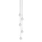 Five small clear spheres from this Clérachic pendant light hang at staggered heights on dark cords on a white backdrop.