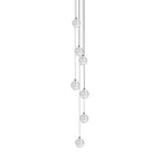Seven clear spheres of this Clérachic pendant light hang close together on thin cords, shown on a white backdrop.
