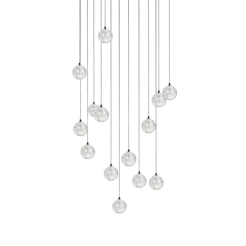 A larger group of clear spheres from this Clérachic pendant light, hung in a loose tall arrangement on white.