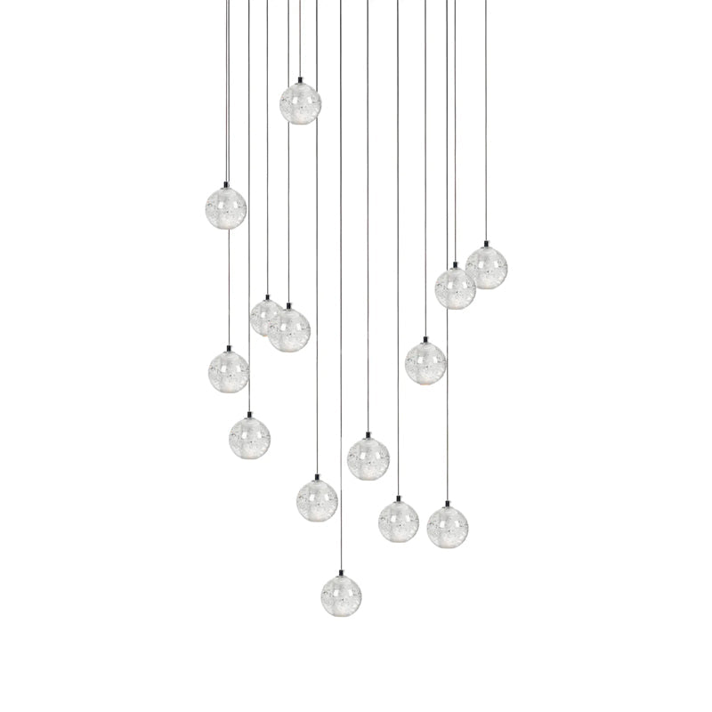 Thirteen or so clear spheres of this Clérachic pendant light hang in a staggered column on thin cords on white.