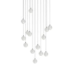 Thirteen or so clear spheres of this Clérachic pendant light hang in a staggered column on thin cords on white.