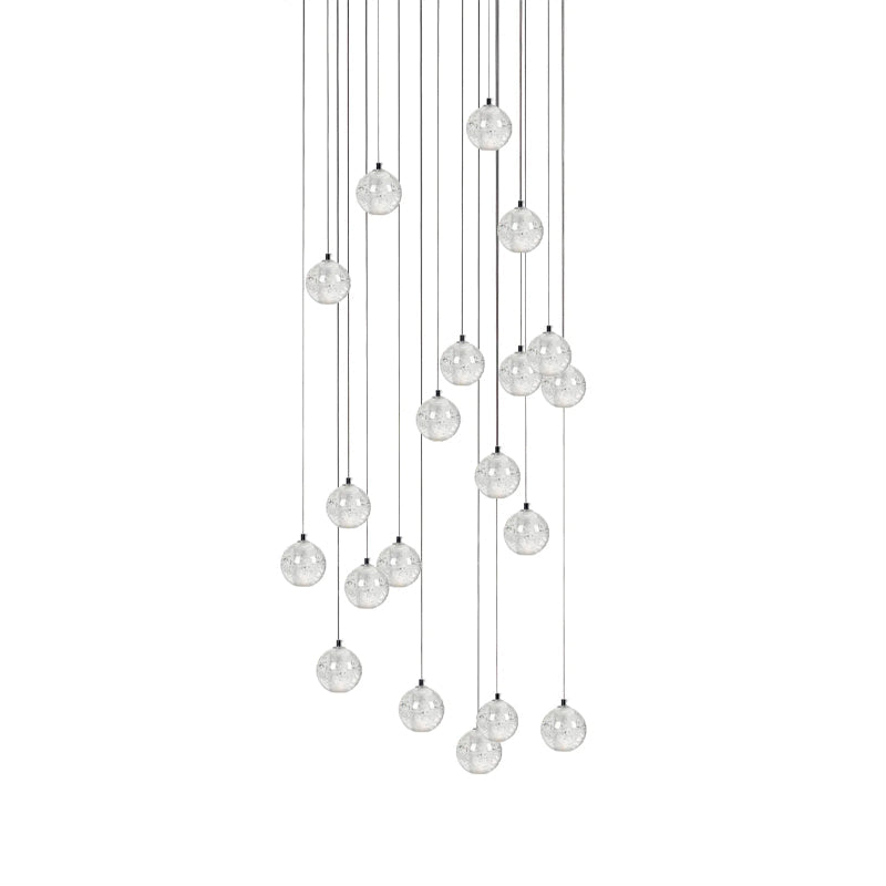 A fuller cluster of clear spheres from this Clérachic pendant light hangs in a tall oval shape on a white backdrop.