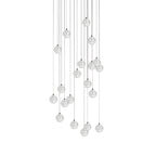 A fuller cluster of clear spheres from this Clérachic pendant light hangs in a tall oval shape on a white backdrop.
