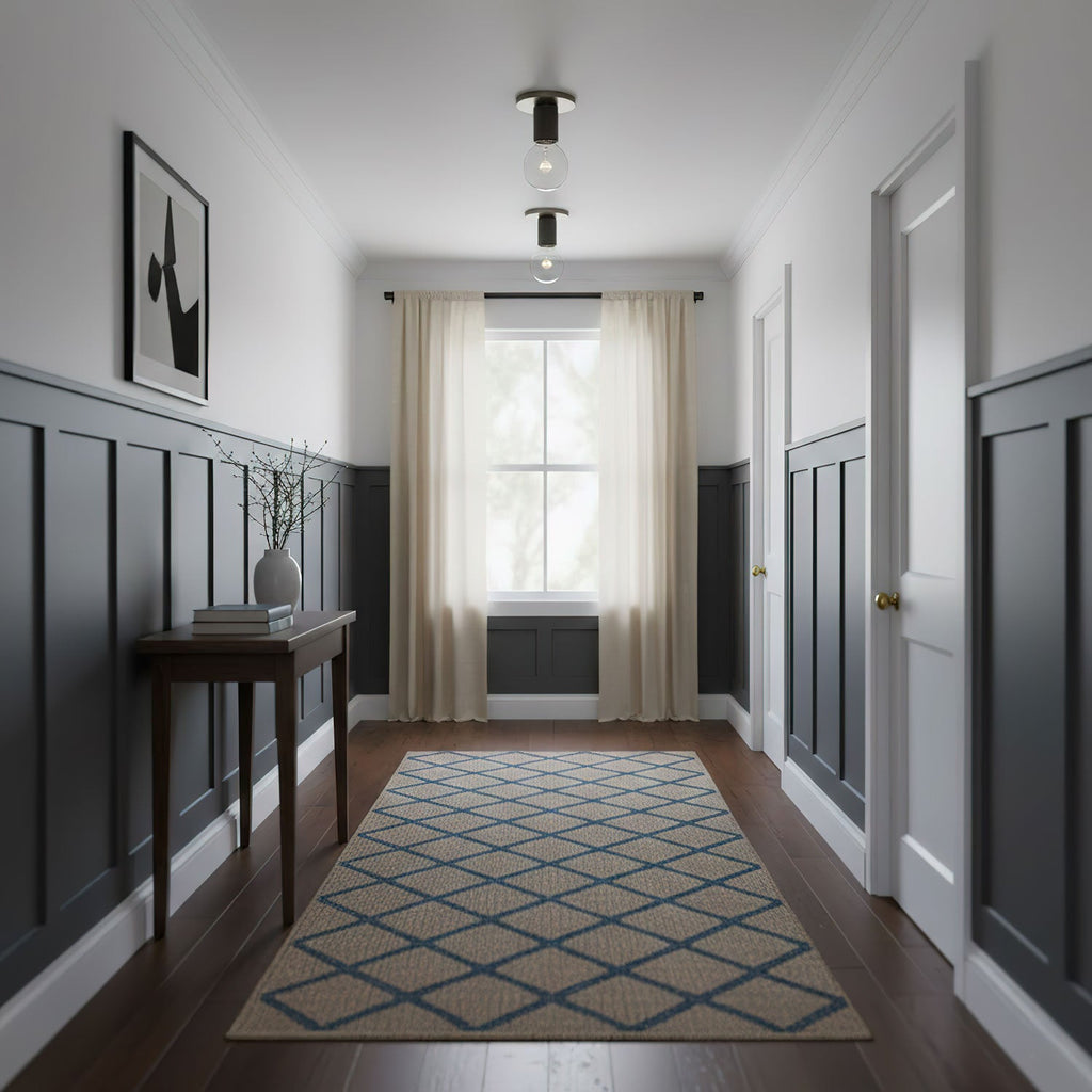 Hallway with dark panelled walls and a diamond-pattern rug, two small ceiling lights lit above, a Clérachic flush mount.