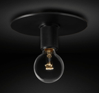 Wide black ceiling plate with a knurled socket and an unlit globe bulb, on a dark background, a Clérachic flush mount.