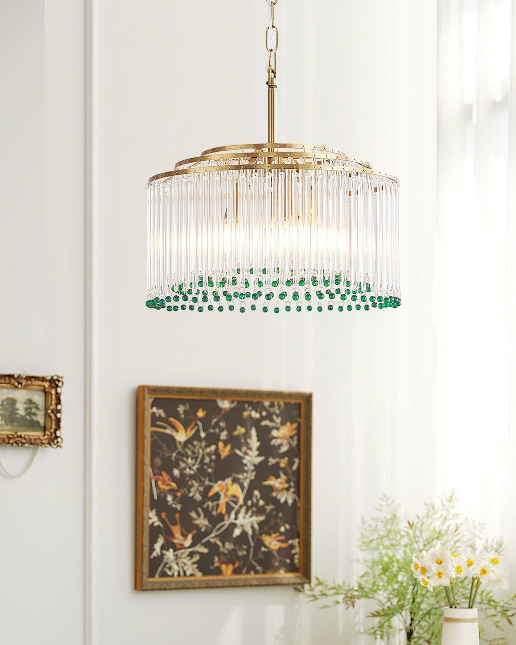 Hanging near a botanical print in a dark wooden frame, this Clérachic glass rod chandelier has a ring of green beads at its base.
