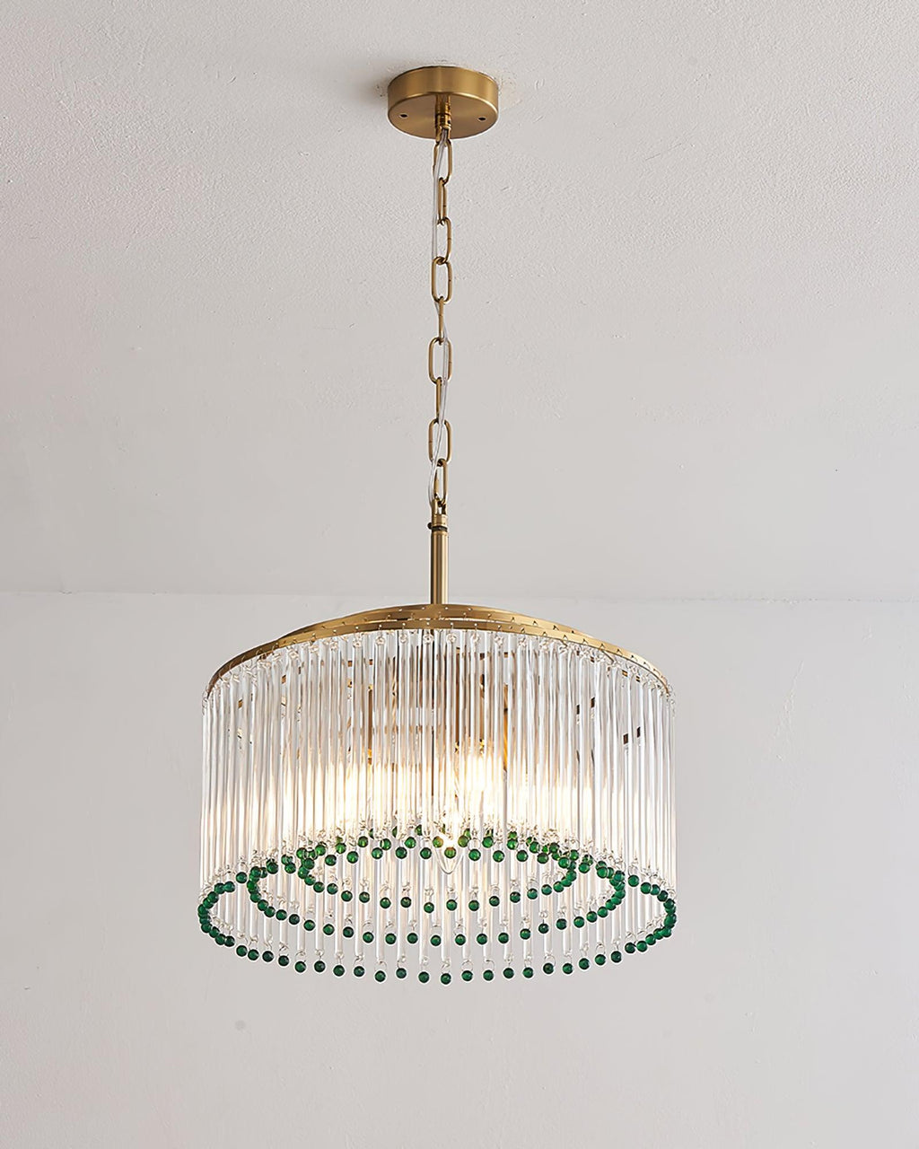 From below, this Clérachic chandelier shows rings of green beads inside its drum of clear glass rods and a gold top ring.