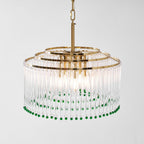 Angled close view of this Clérachic chandelier, with three tiers of gold rings above clear glass rods and green beads.