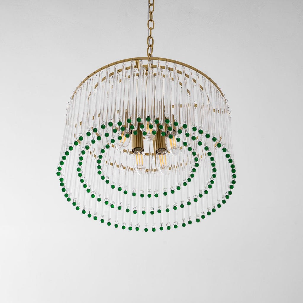 This Clérachic chandelier seen from below shows its brass candle sockets, three rings of green beads and a gold chain above.