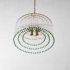 This Clérachic chandelier seen from below shows its brass candle sockets, three rings of green beads and a gold chain above.