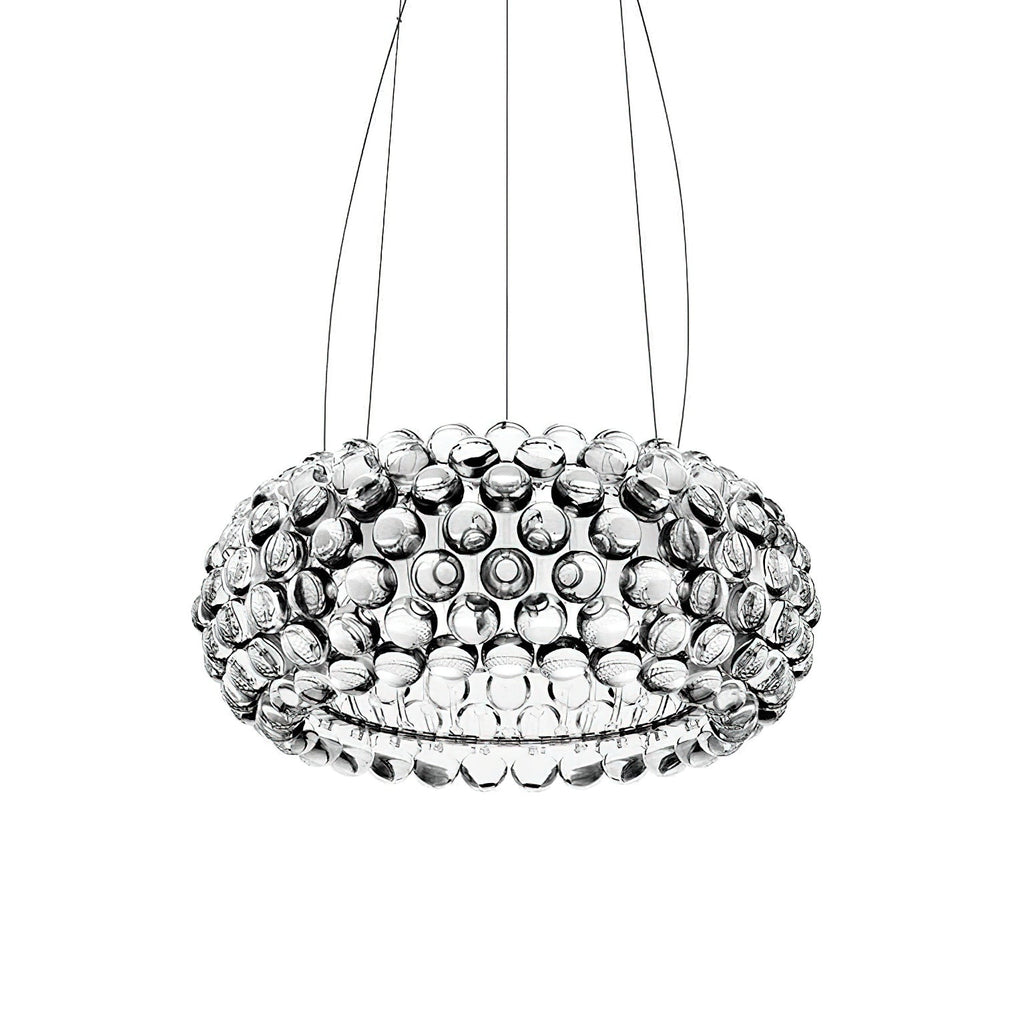 A clear sphere dome pendant seen from slightly below hangs from three fine cables against a white backdrop, from Clérachic.