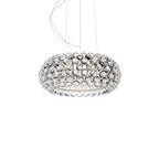 A smaller clear sphere pendant hangs from fine cables against a white backdrop, its spheres catching the light, from Clérachic.