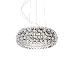 A clear sphere pendant of medium size, unlit, hangs from fine cables against a white backdrop, from Clérachic.