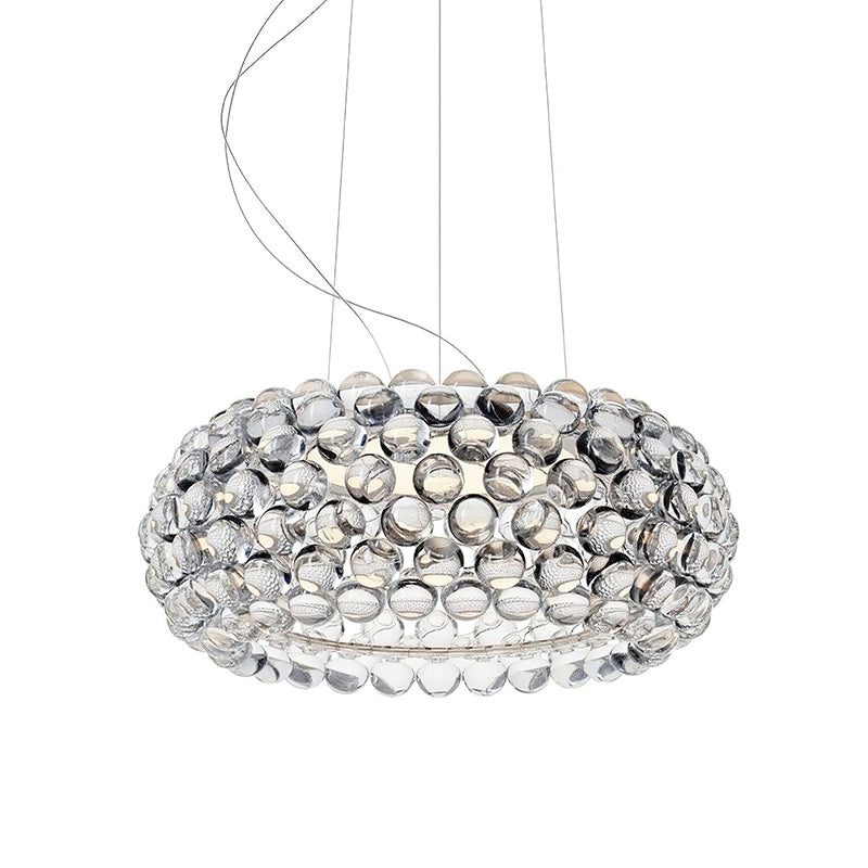 A larger clear sphere pendant hangs from fine cables against a white backdrop, from Clérachic.