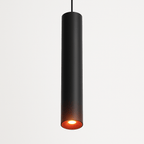 Clérachic cluster pendant light in matte black, its underside glowing warm white against a plain white backdrop.