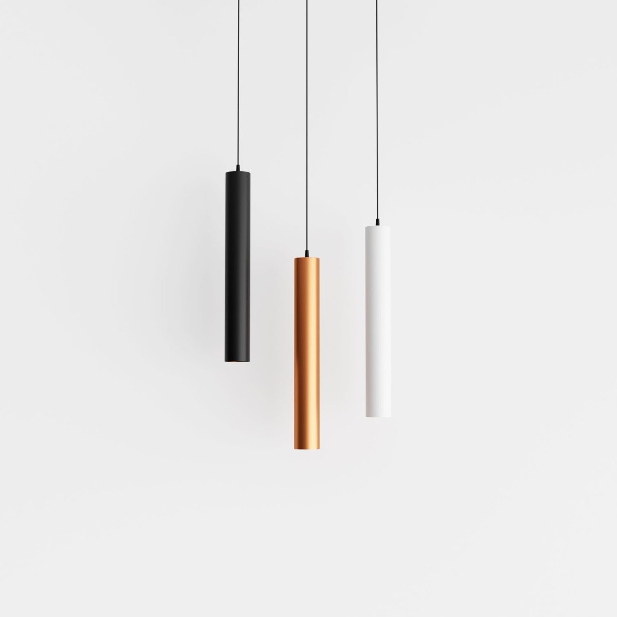 Clérachic cluster pendant light shown together in black, gold and white finishes hanging side by side on white.