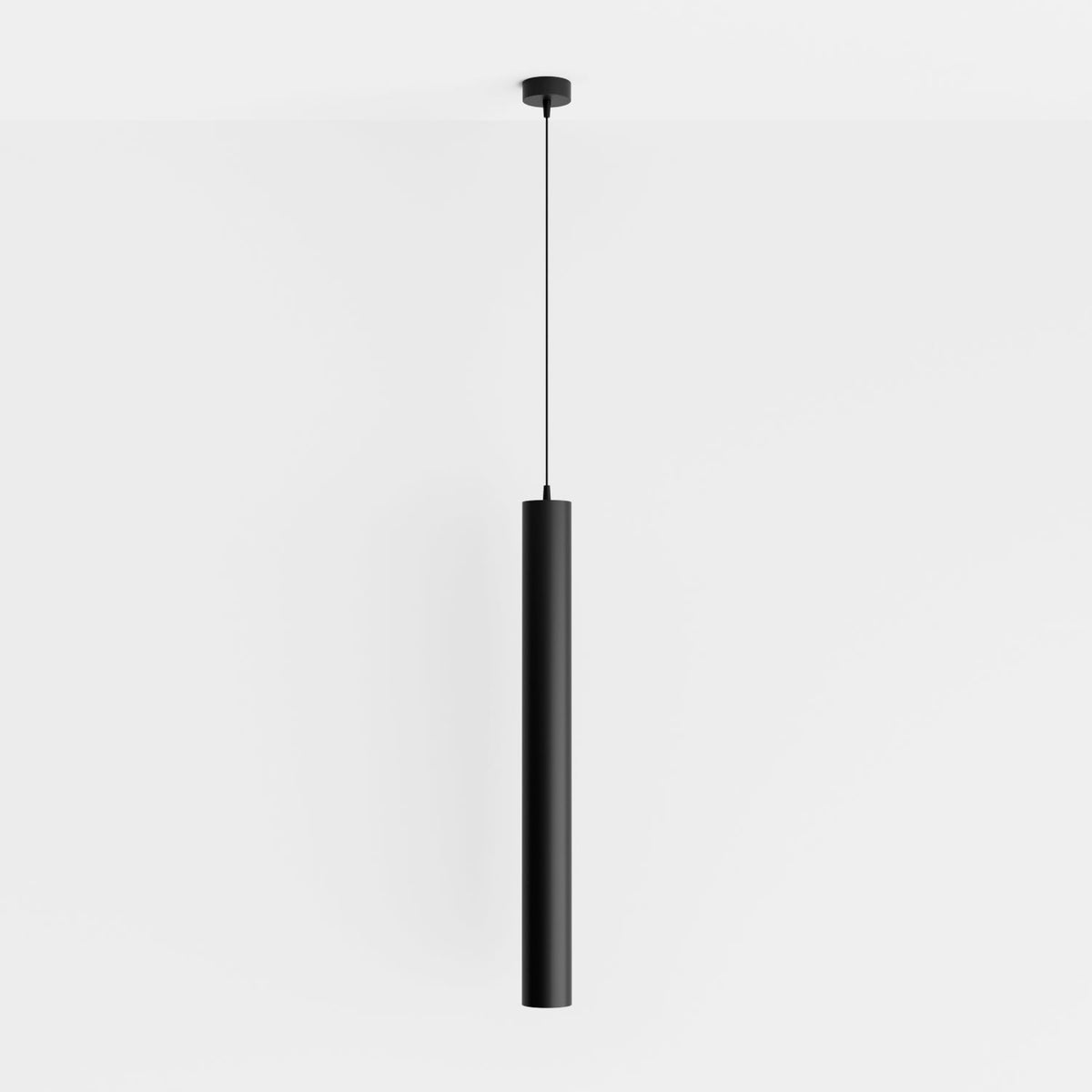 Clérachic cluster pendant light in matte black hangs from a round ceiling canopy on a plain white wall backdrop.