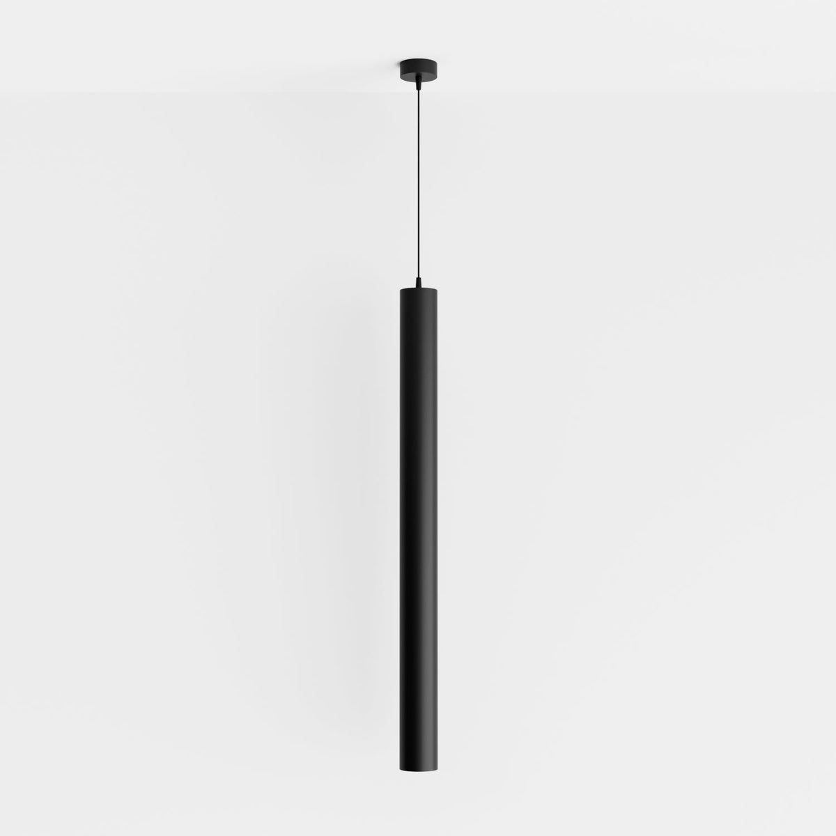 Clérachic cluster pendant light in matte black drops from a black ceiling canopy against a soft white studio wall.