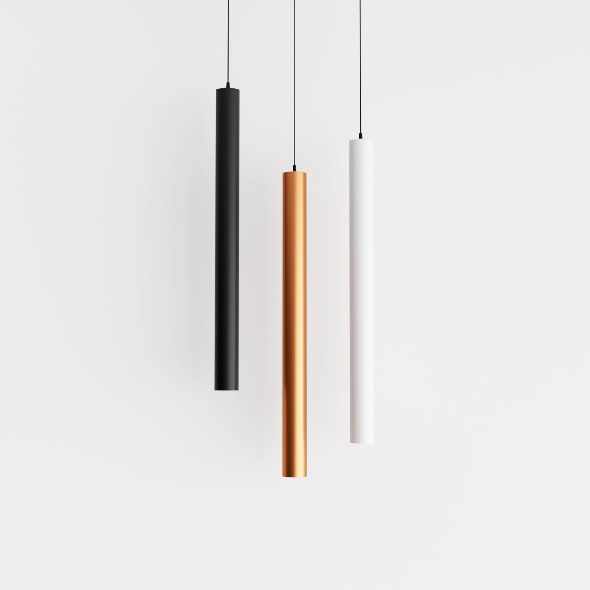 Clérachic cluster pendant light group in black, gold and white cylinders hanging evenly spaced on a white ground.