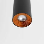 Clérachic cluster pendant light detail in matte black shows its copper-tone reflector ring and frosted lens beneath.