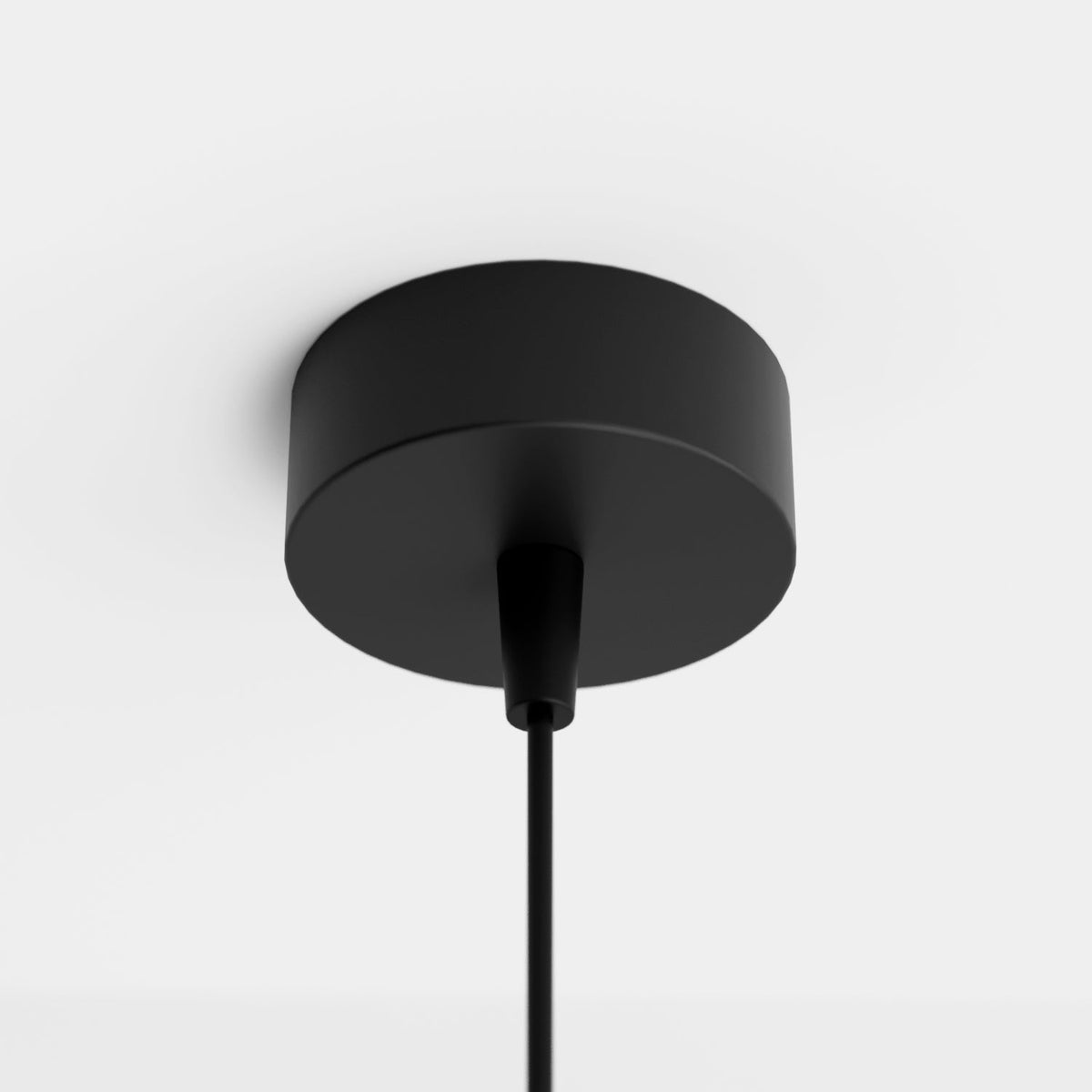 Clérachic cluster pendant light detail of the round black ceiling canopy where the thin suspension cord attaches.