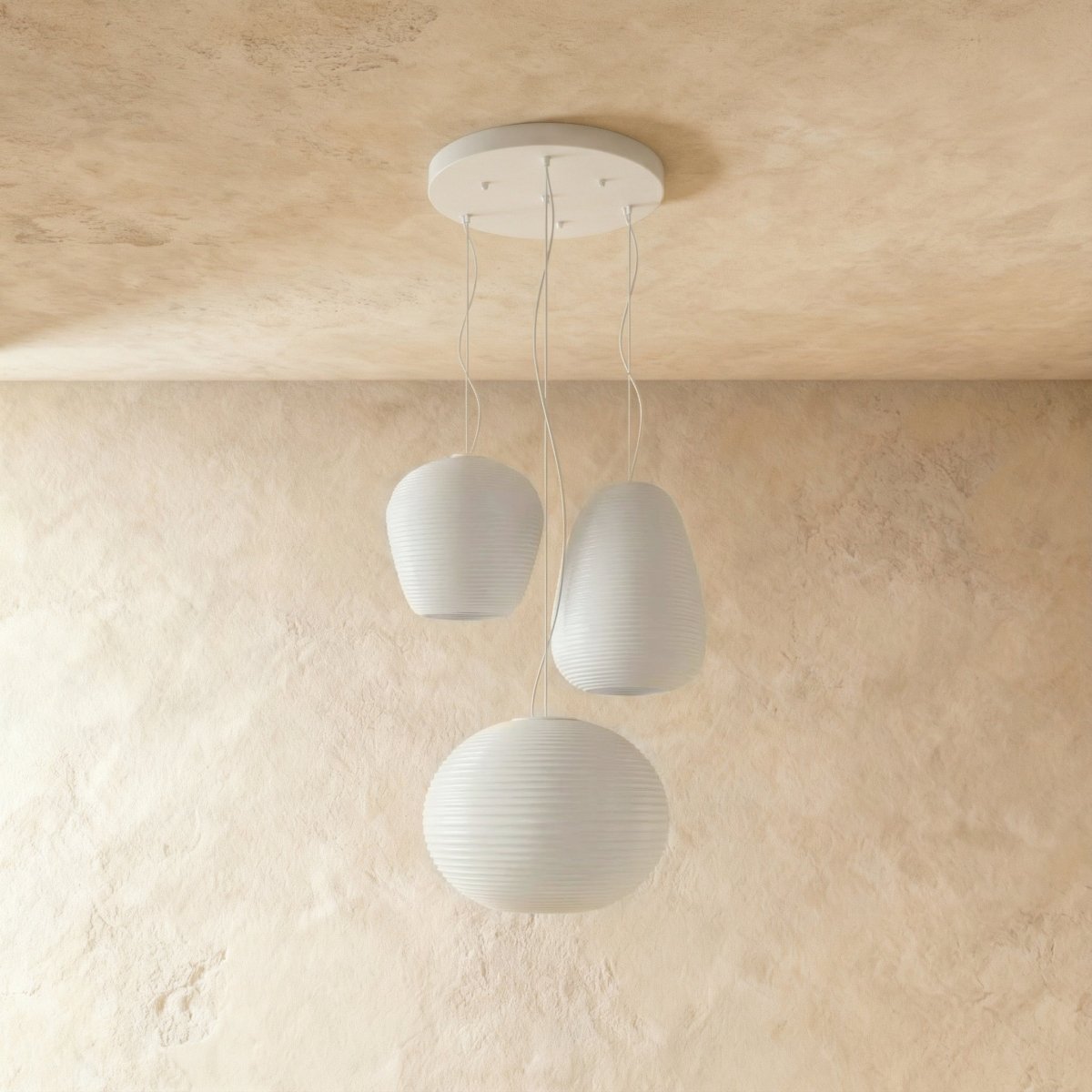 Clérachic three ribbed white glass pendants in egg, apple and wide oval shapes hanging from a white canopy, shown unlit.