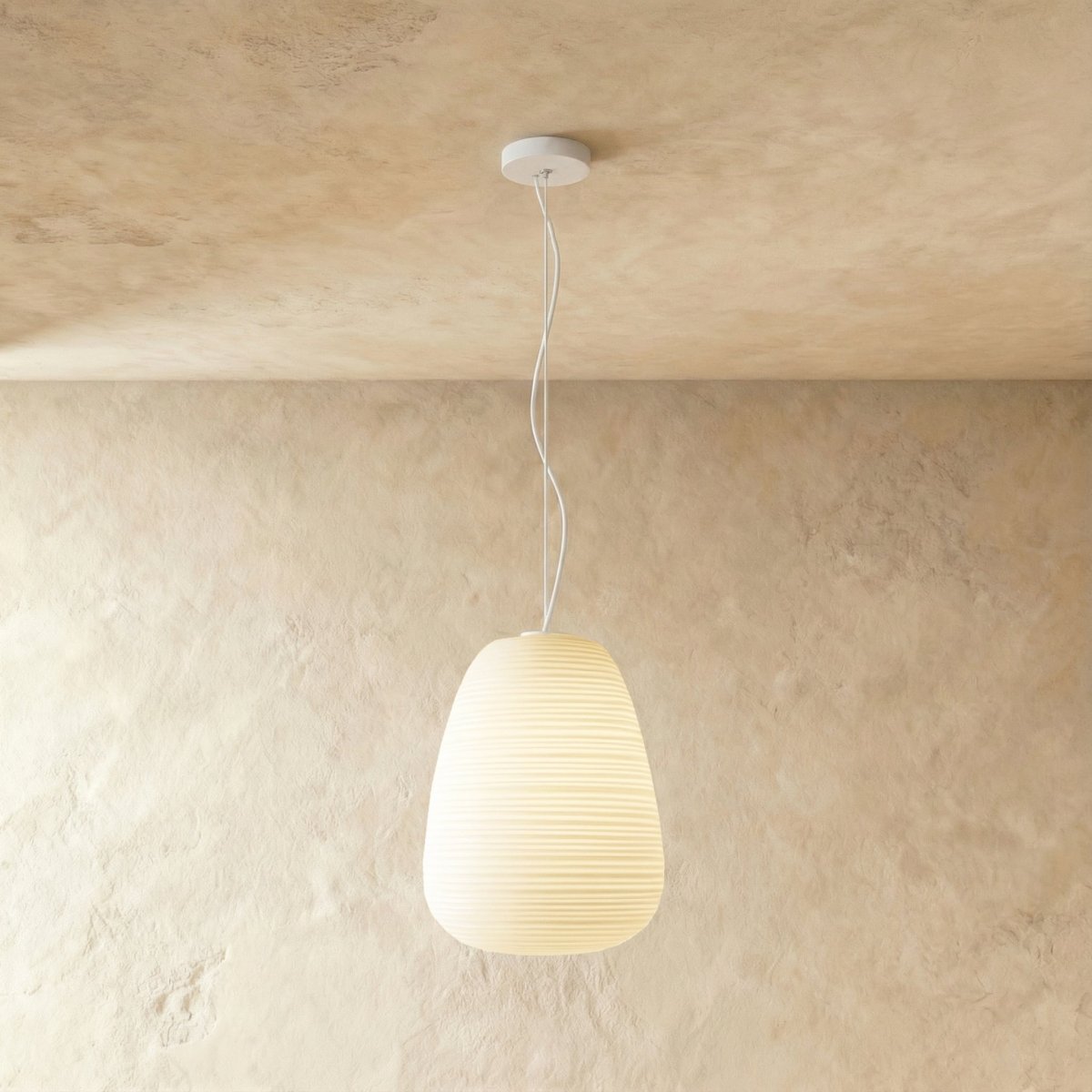 Clérachic tall egg-shaped ribbed opal glass pendant glowing softly on a thin white cord from a small white canopy.
