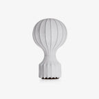 Clérachic table lamp on a light grey backdrop, its fine vertical ribs running from the round shade down to the ribbed base.