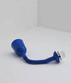 Blue cap, stretch-coil cable and lamp holder of this Clérachic pendant laid on a white floor, with the glass shade removed.
