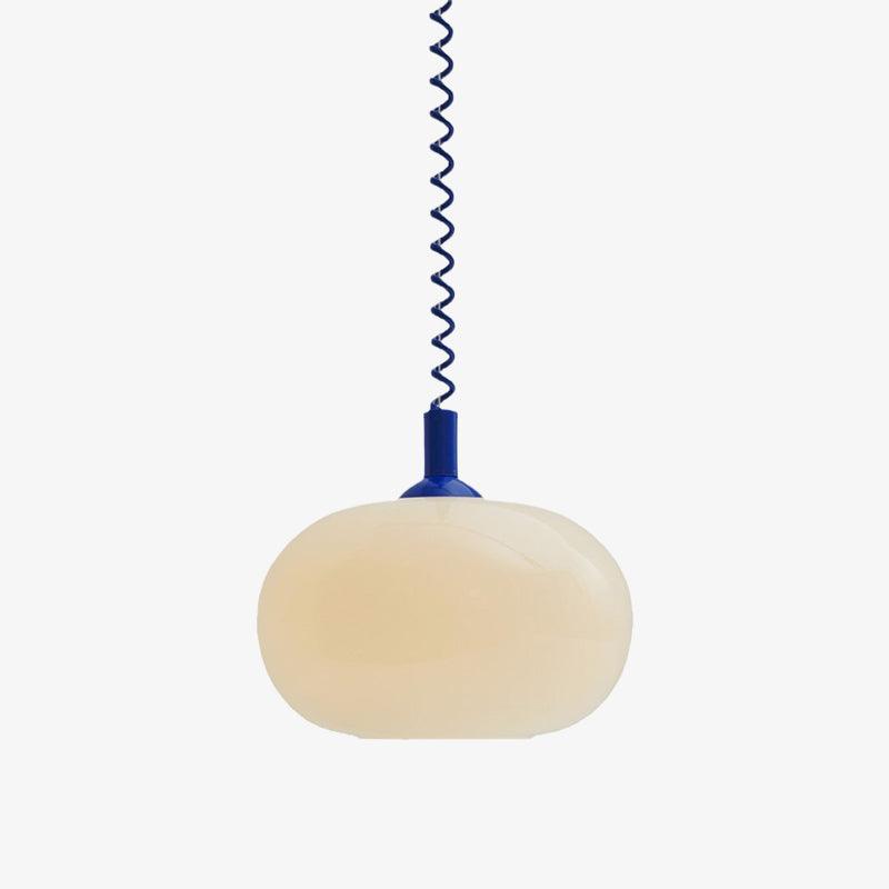 Lit Clérachic pendant with a blue cap and blue coil cable, its cream shade photographed on a pale grey backdrop.