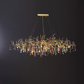 Clérachic multicolour raindrop chandelier, glass droplets hung along a gold branch frame on black.