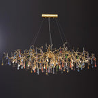 A wider Clérachic raindrop chandelier on black, its branches spreading before the drops fall.
