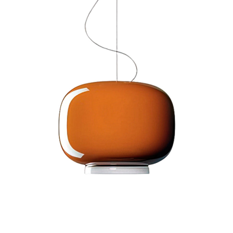 Glossy orange glass shade with a white lower band, this Clérachic pendant shown on a plain white backdrop.