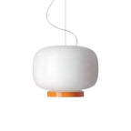 White glass lantern pendant with an orange band at its base, this Clérachic light on a plain white backdrop.