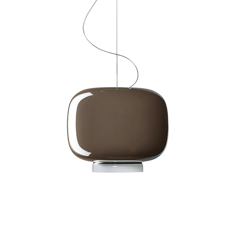 Glossy taupe-brown glass shade with a white base, this Clérachic pendant on a plain white backdrop.