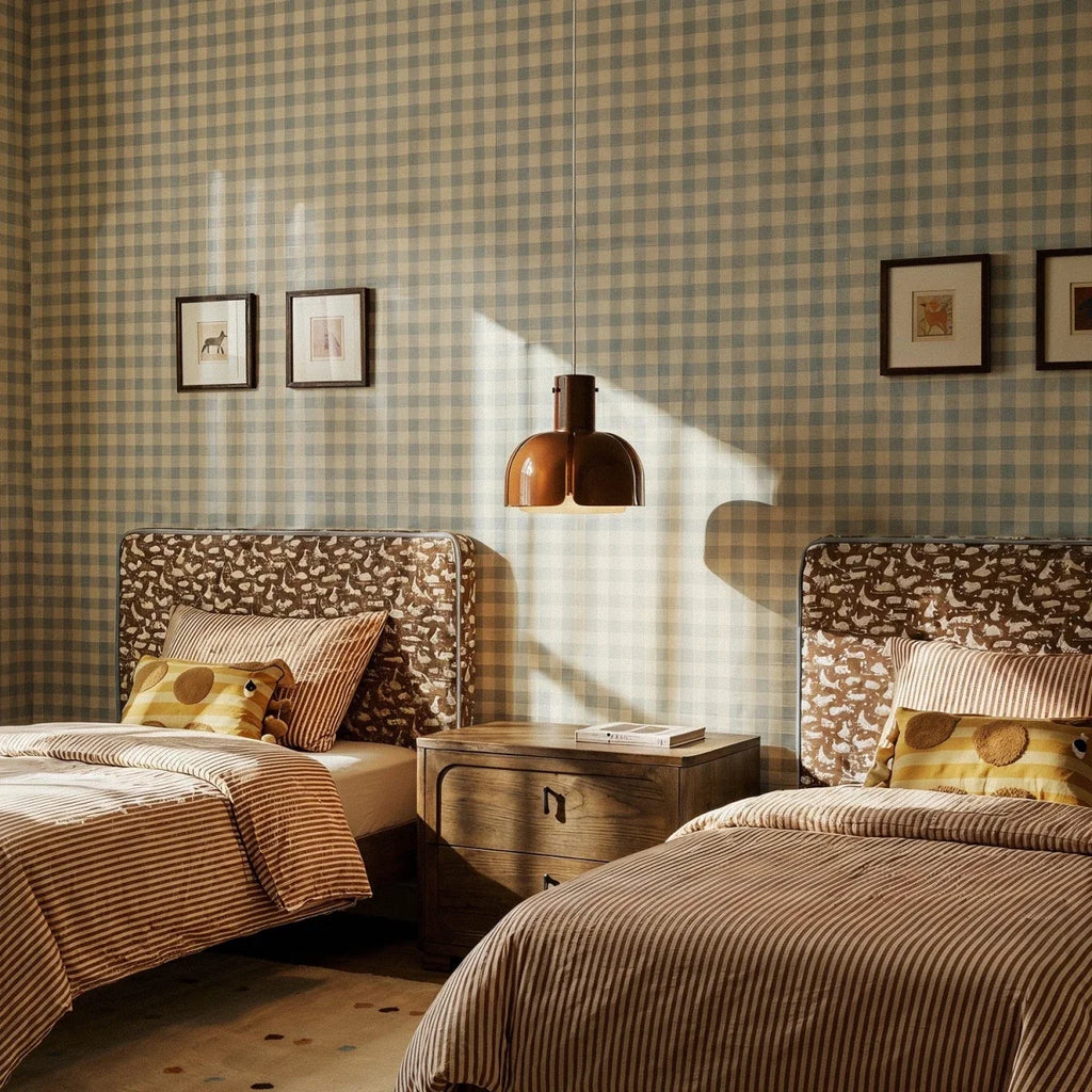 Clérachic glossy brown glass pendant hanging between twin beds in a bedroom with gingham walls and striped bedding.