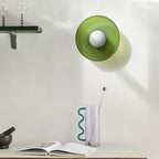Green glass drum from the Clérachic coloured glass flush mount range, wall-mounted as a sconce above a console table.