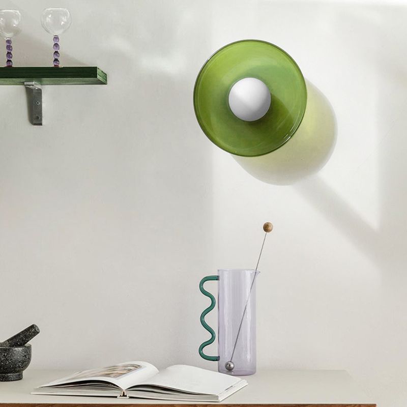 Green glass drum from the Clérachic coloured glass flush mount range, wall-mounted as a sconce above a console table.