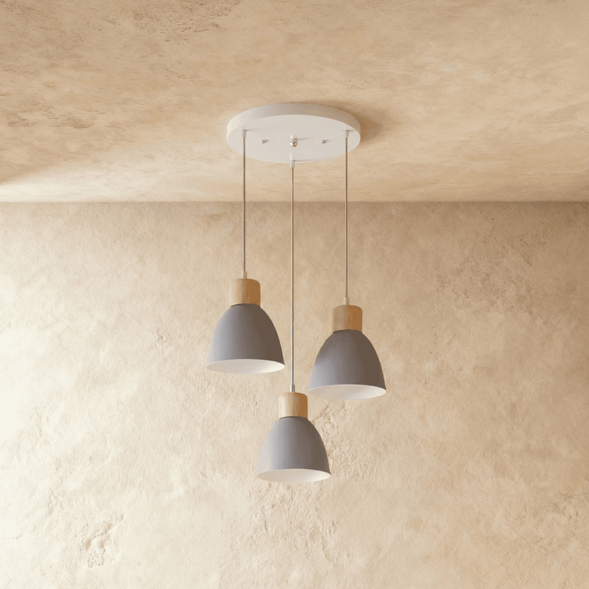 A Clérachic three-head wood disc pendant light in matte grey hangs from a round canopy against a warm plaster ceiling.