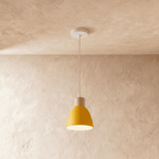 Closer view of the Clérachic single-head yellow wood disc pendant light showing its wood collar and metal shade.
