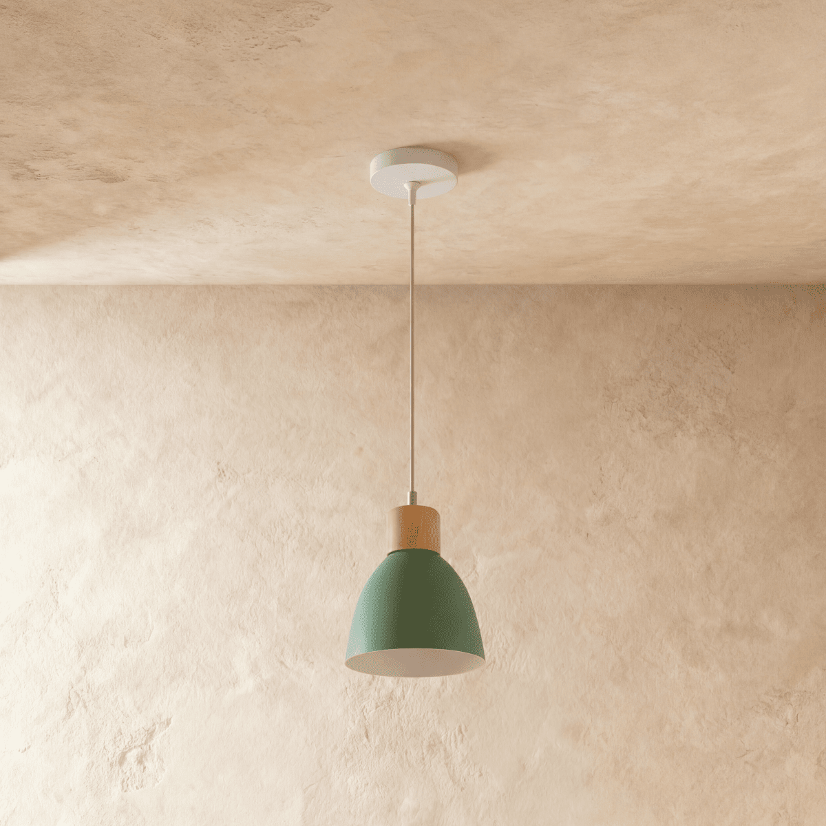 A single Clérachic wood disc pendant light in sage green hangs from a round ceiling canopy over a plaster wall.