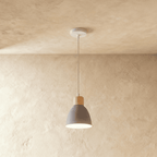 Side angle of the Clérachic single-head grey wood disc pendant light with its wood collar and slim ceiling cable.