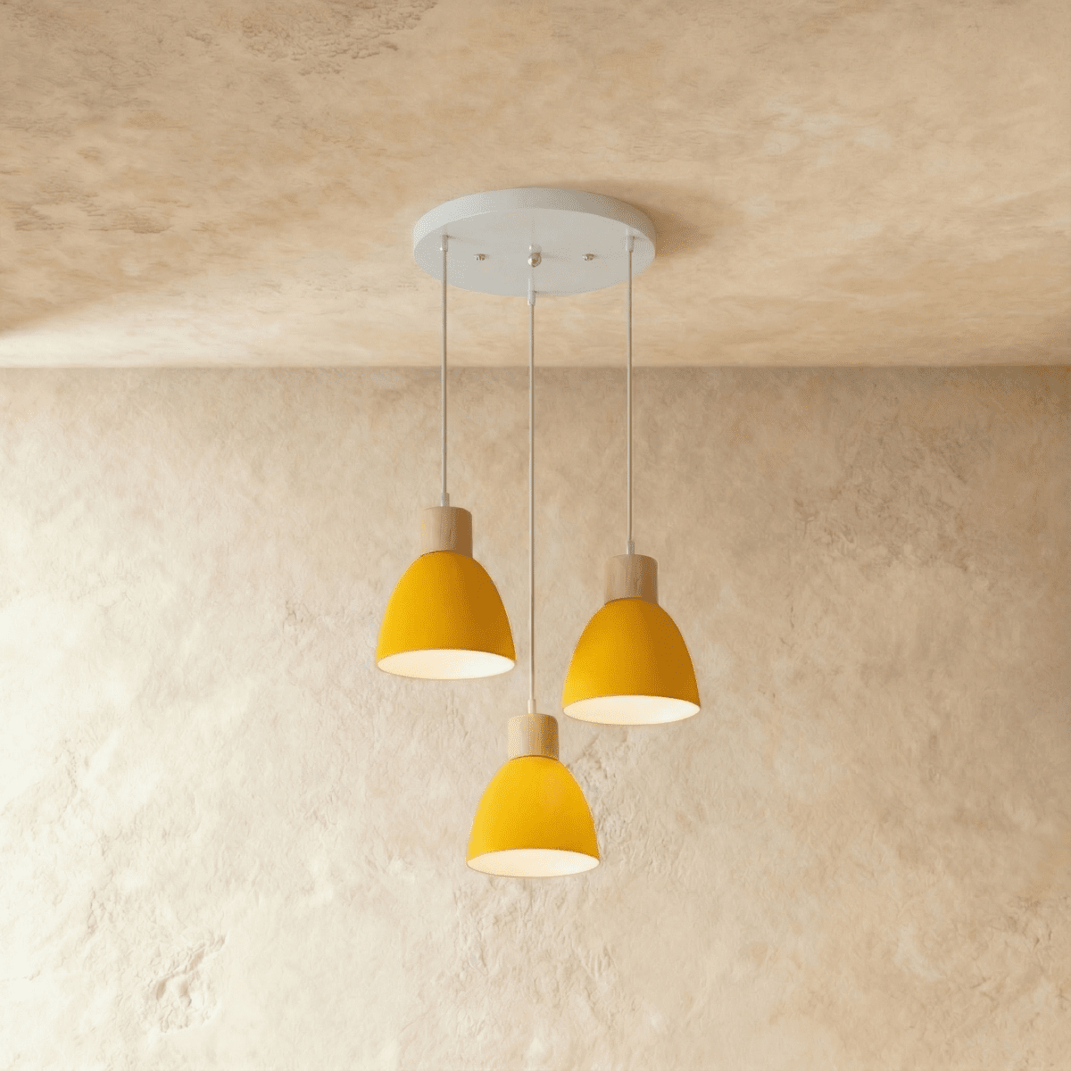 Closer view of the Clérachic three-head yellow wood disc pendant light cluster on its round ceiling canopy.