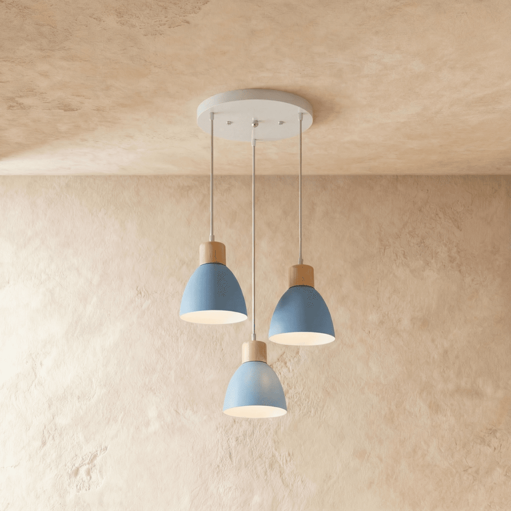 Angled view of the Clérachic three-head blue wood disc pendant light cluster hanging from its round canopy.
