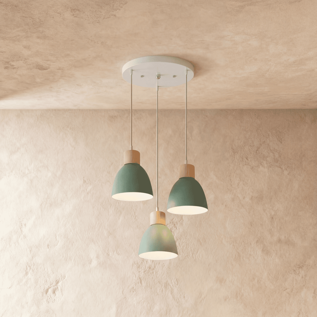 Closer view of the Clérachic three-head green wood disc pendant light cluster on its round white ceiling canopy.