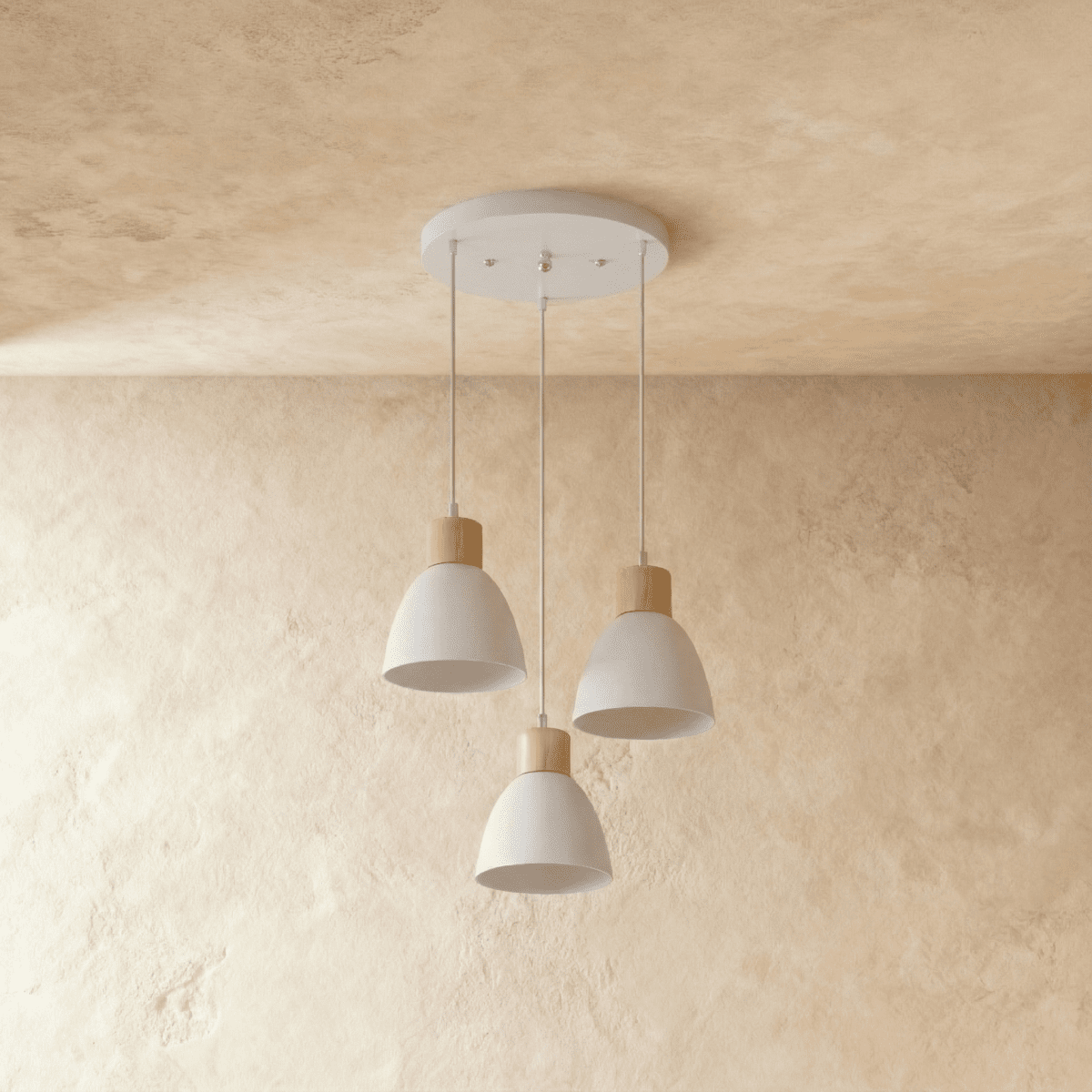 Three Clérachic wood disc pendant lights in warm white cluster from a round canopy over a plaster backdrop.