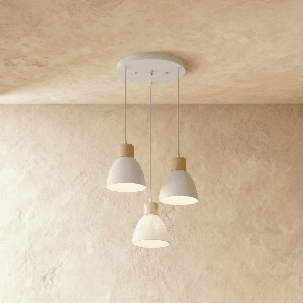 Angled view of the Clérachic three-head white wood disc pendant light cluster hanging from its round canopy.