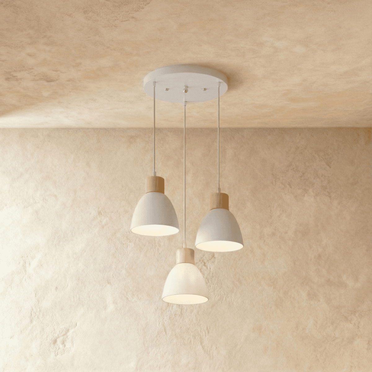 Angled view of the Clérachic three-head white wood disc pendant light cluster hanging from its round canopy.