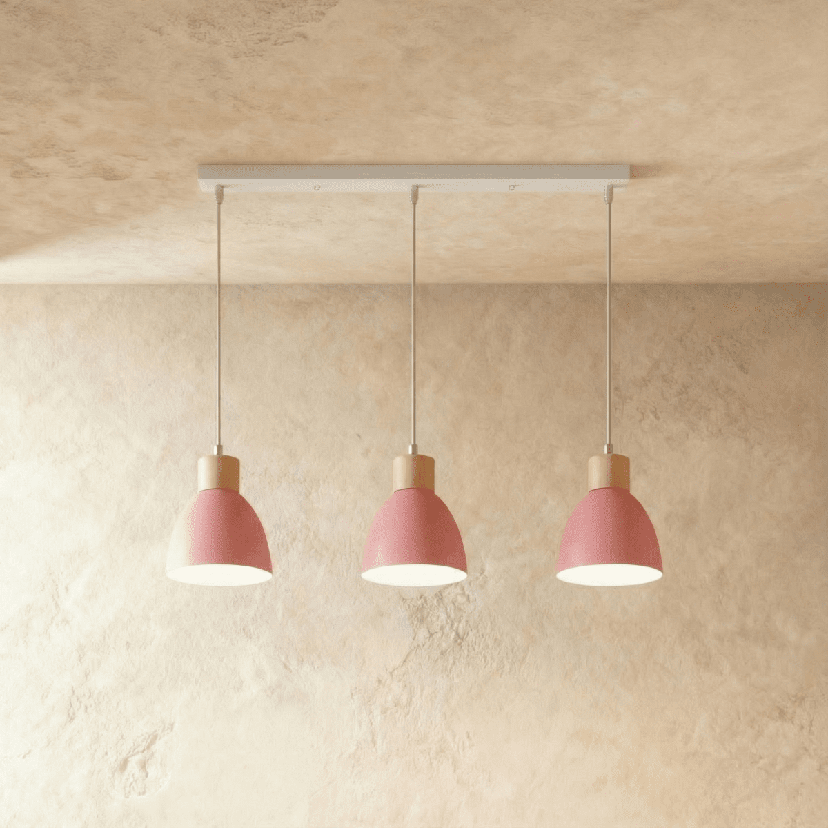 Closer view of the Clérachic three-head pink wood disc pendant light row on its slim linear ceiling bar.